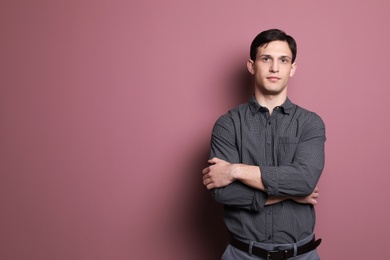 Photo of Portrait of confident young man on color background