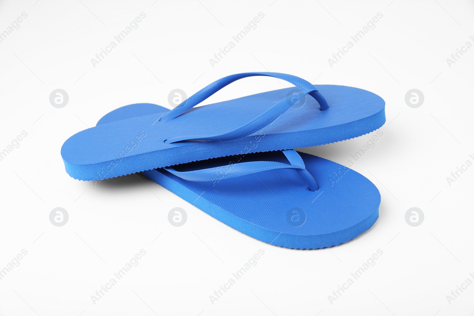 Photo of Stylish blue flip flops on white background