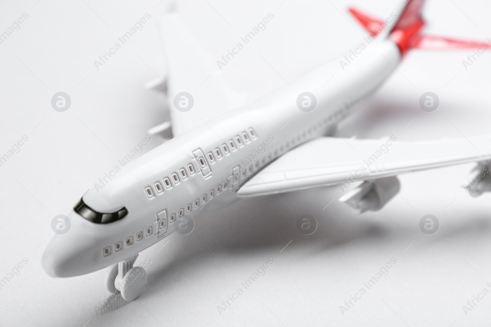 Photo of Toy airplane on light background, closeup view