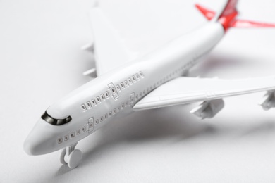 Toy airplane on light background, closeup view