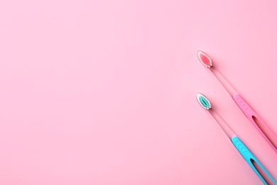 Photo of Manual toothbrushes on color background. Dental care