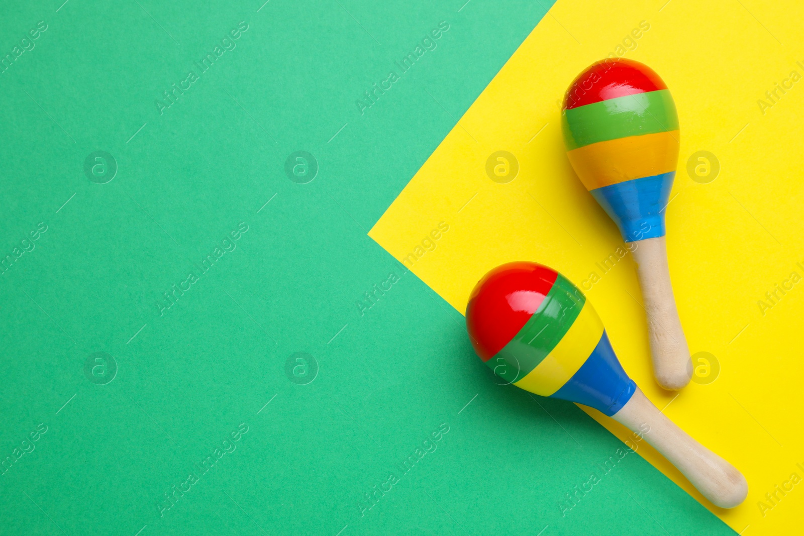 Photo of Maracas on colorful background, flat lay with space for text. Musical instrument