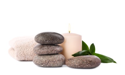 Photo of Spa stones, candle, towel and bamboo leaves on white background