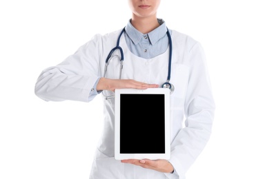 Photo of Female doctor holding modern tablet on white background, closeup. Space for design