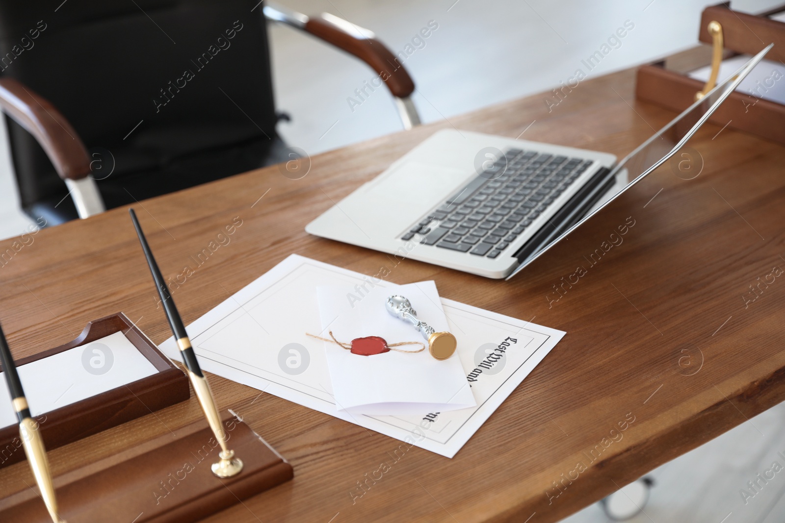 Photo of Vintage stamp, laptop and documents on desk in notary's office