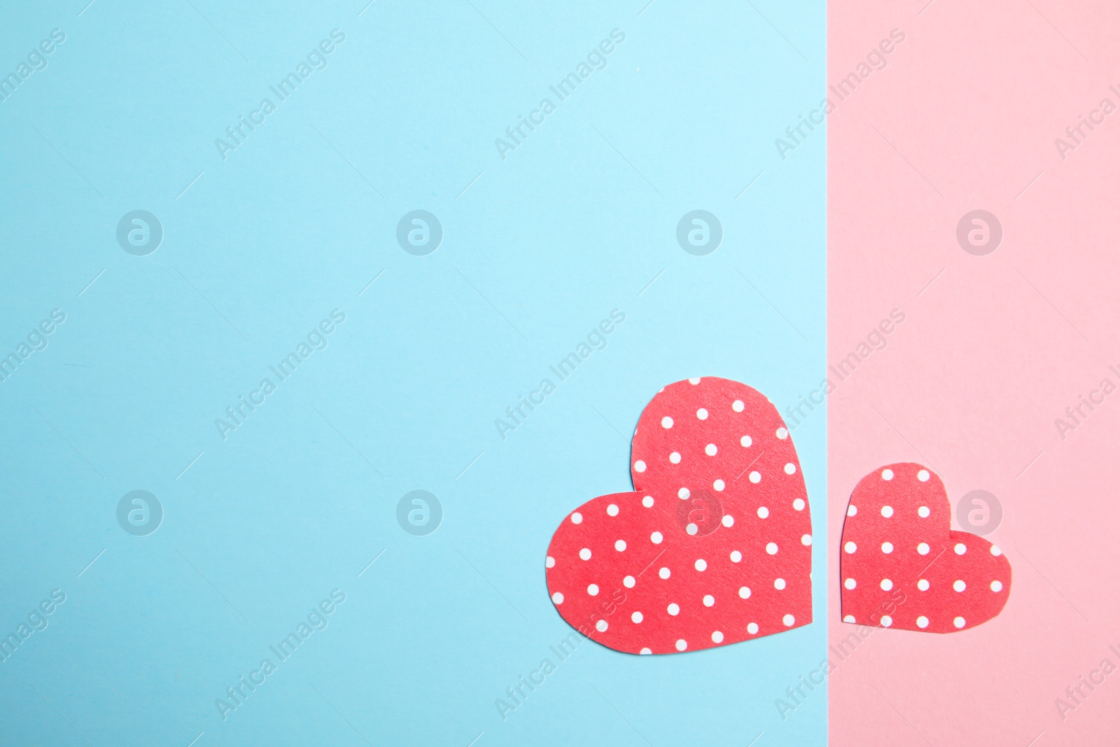 Photo of Small paper hearts on color background, top view