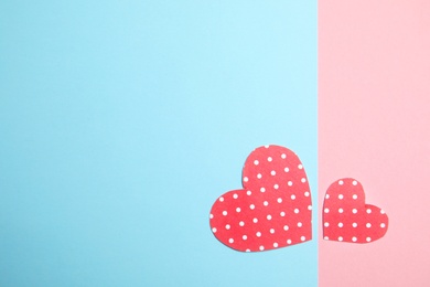 Photo of Small paper hearts on color background, top view