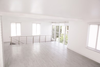 Empty room with windows and laminated floor