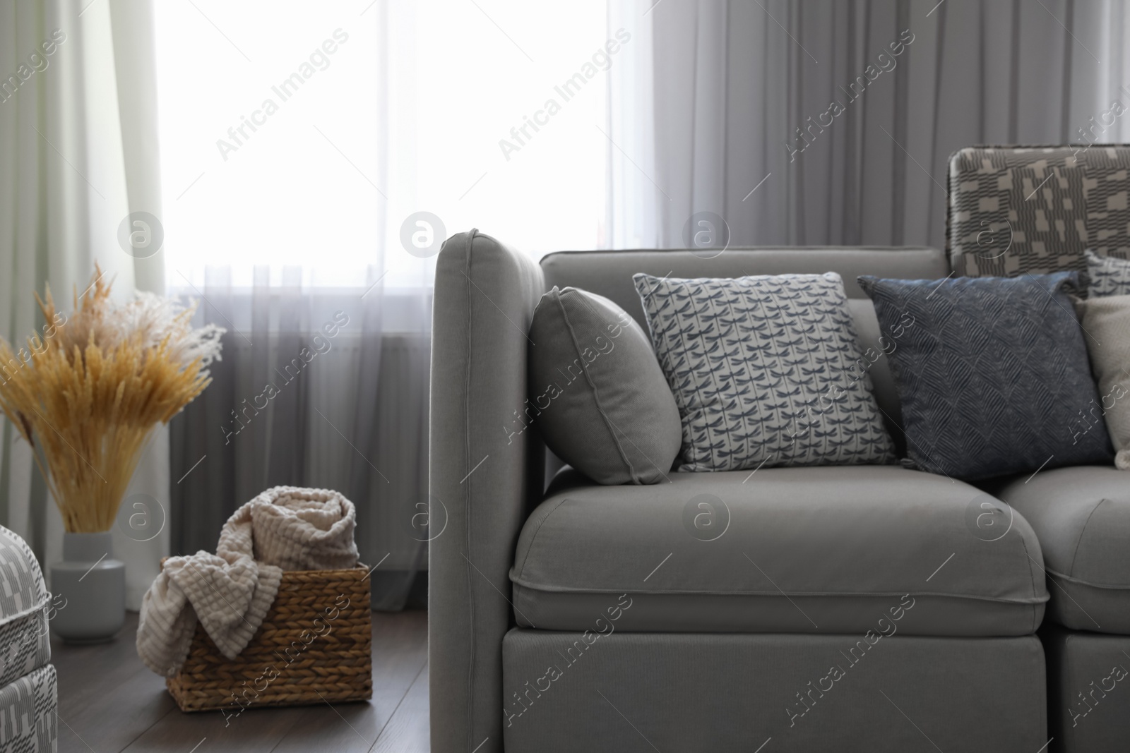 Photo of Elegant living room with comfortable sofa near window. Interior design