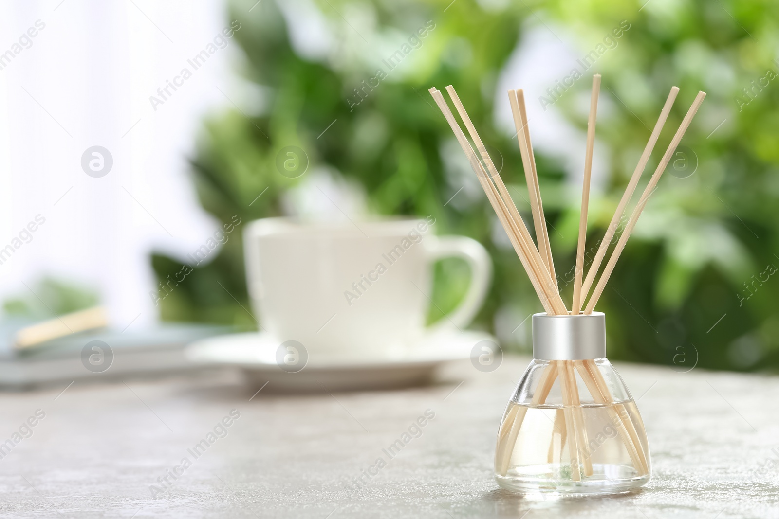 Photo of Aromatic reed freshener on table in room