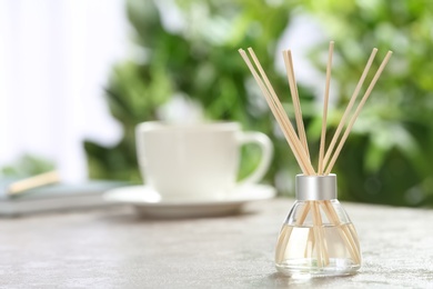 Aromatic reed freshener on table in room