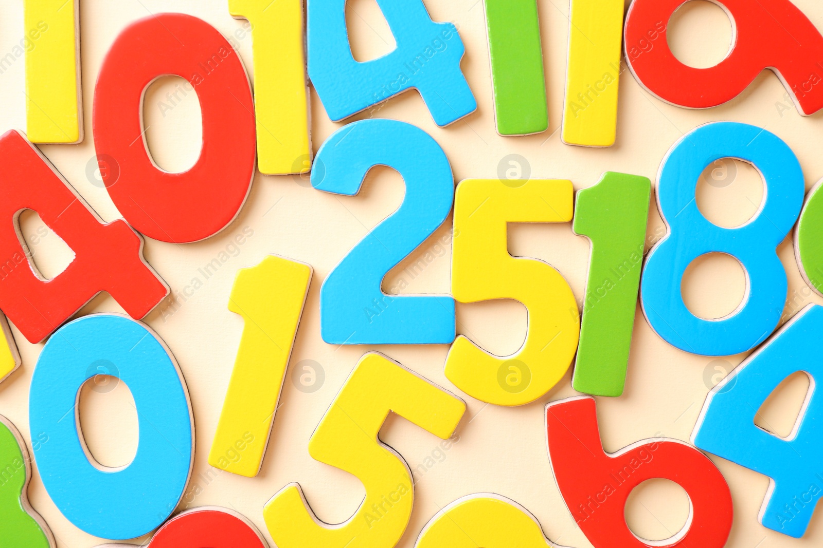 Photo of Colorful numbers on beige background, flat lay