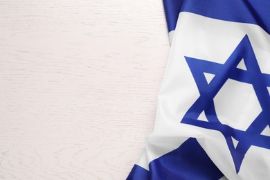 Flag of Israel on white wooden background, top view and space for text. National symbol