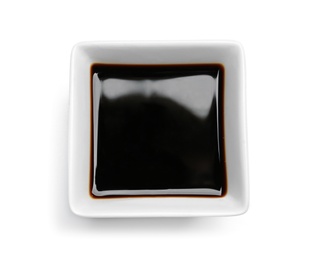 Photo of Dish of soy sauce on white background, top view