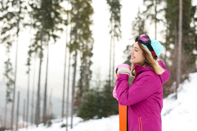 Photo of Female skier on slope at resort, space for text. Winter vacation