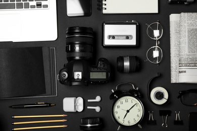 Flat lay composition with equipment for journalist on black background