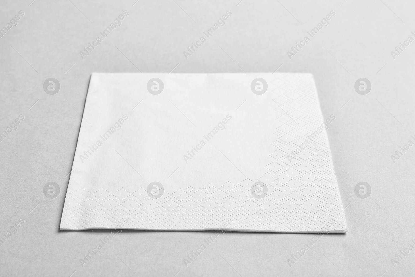 Photo of Clean napkin on grey background. Personal hygiene