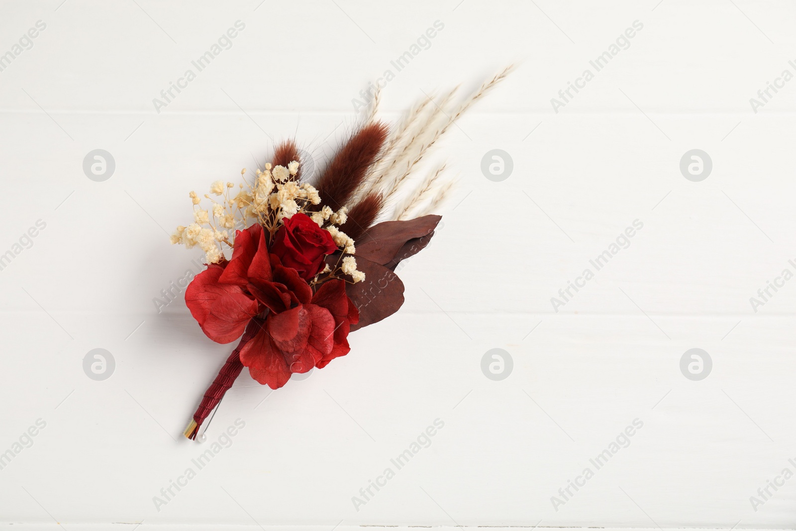 Photo of Beautiful boutonniere on white background, top view. Space for text