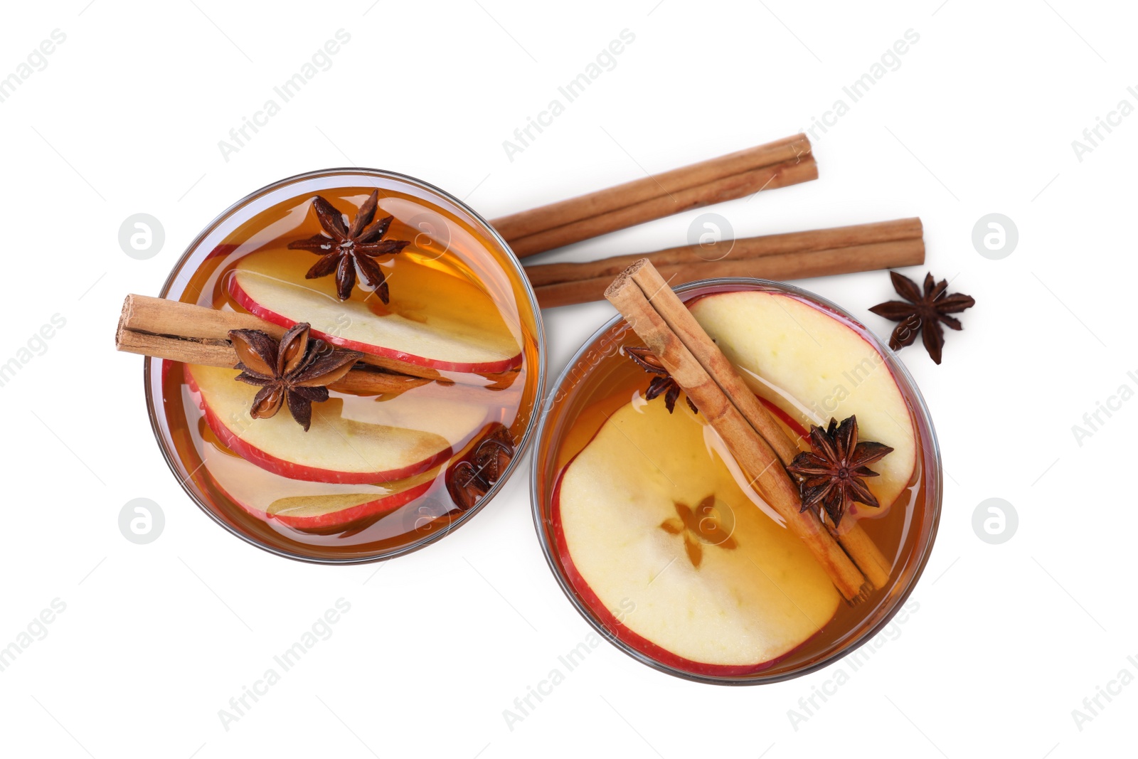 Photo of Hot mulled cider and ingredients on white background, top view