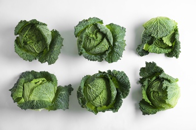 Photo of Fresh savoy cabbages on white background, top view