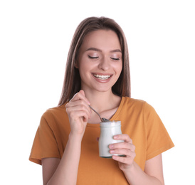 Young attractive woman with tasty yogurt on white background