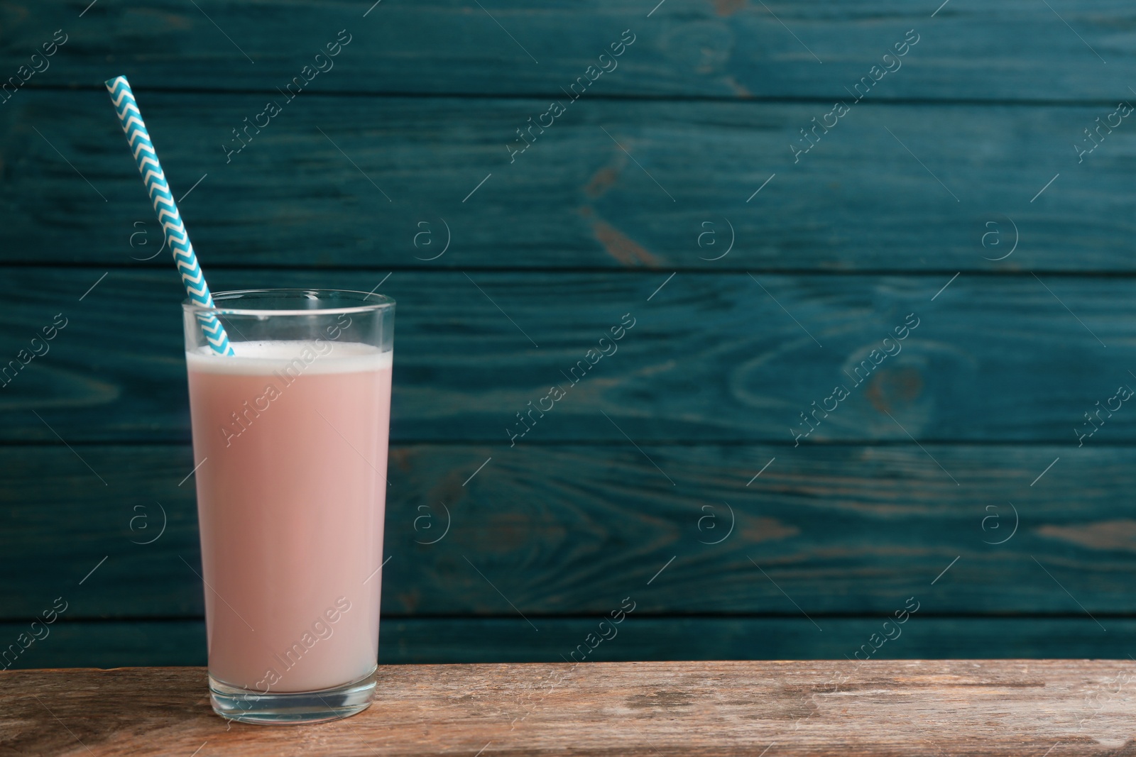 Photo of Protein shake on wooden table, space for text