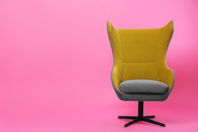 Photo of Comfortable office chair on pink background, space for text