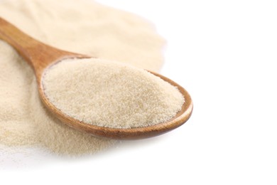 Photo of Spoon and organic semolina on white background, closeup