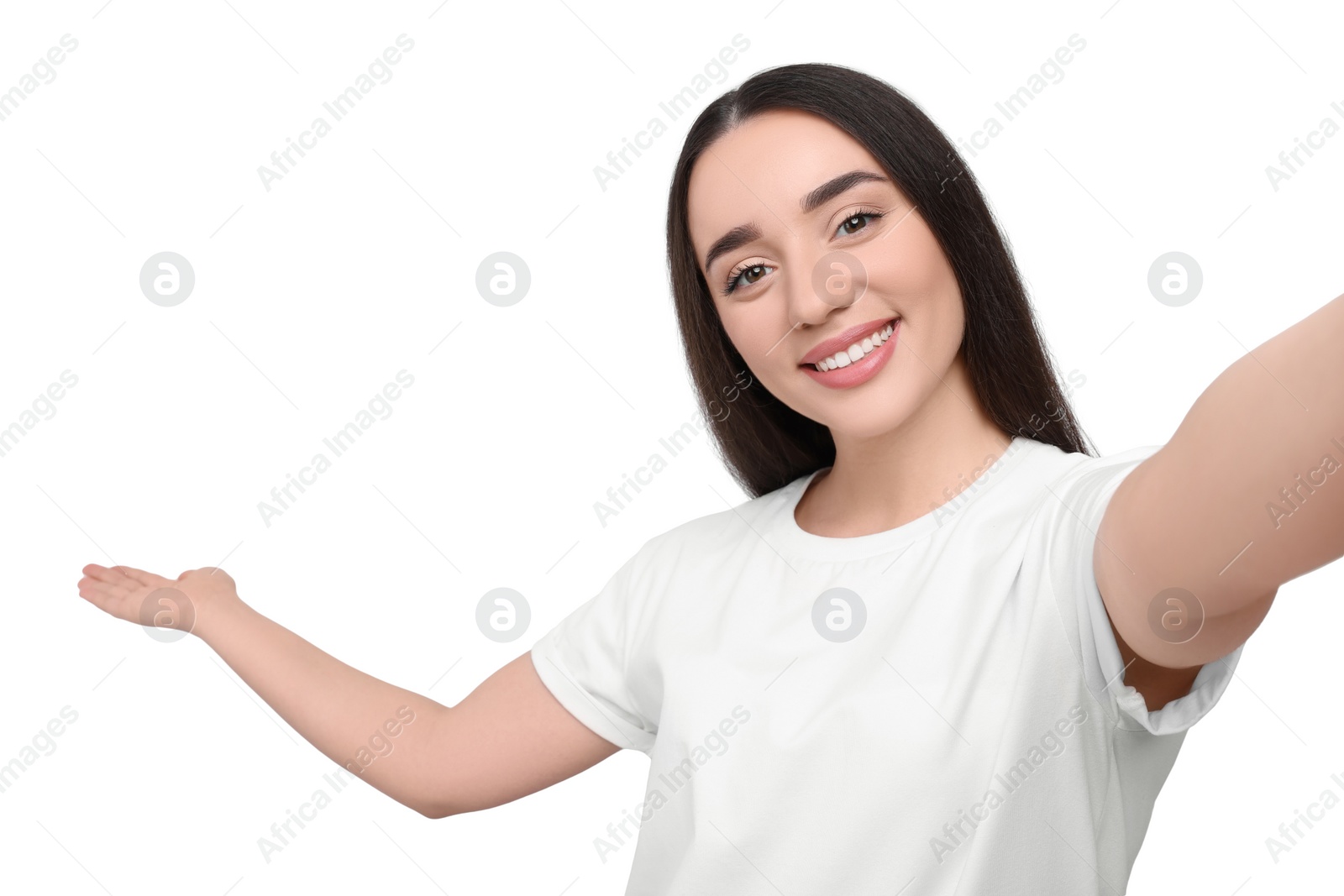 Photo of Smiling young woman taking selfie on white background