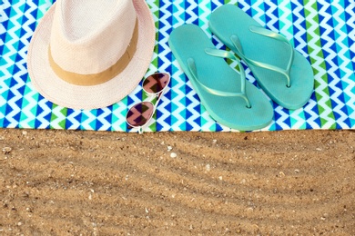 Photo of Composition with beach accessories on sand. Space for text