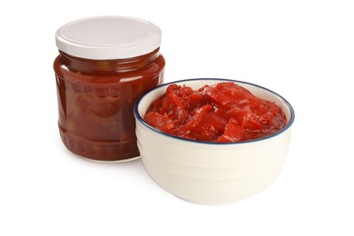 Photo of Glass jar and bowl of delicious lecho on white background