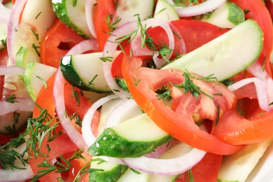 Photo of Delicious salad with fresh vegetables as background, closeup