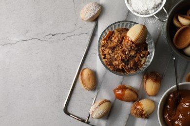 Photo of Delicious walnut shaped cookies with condensed milk on grey table, flat lay. Space for text