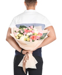 Young man holding beautiful flower bouquet on white background, back view