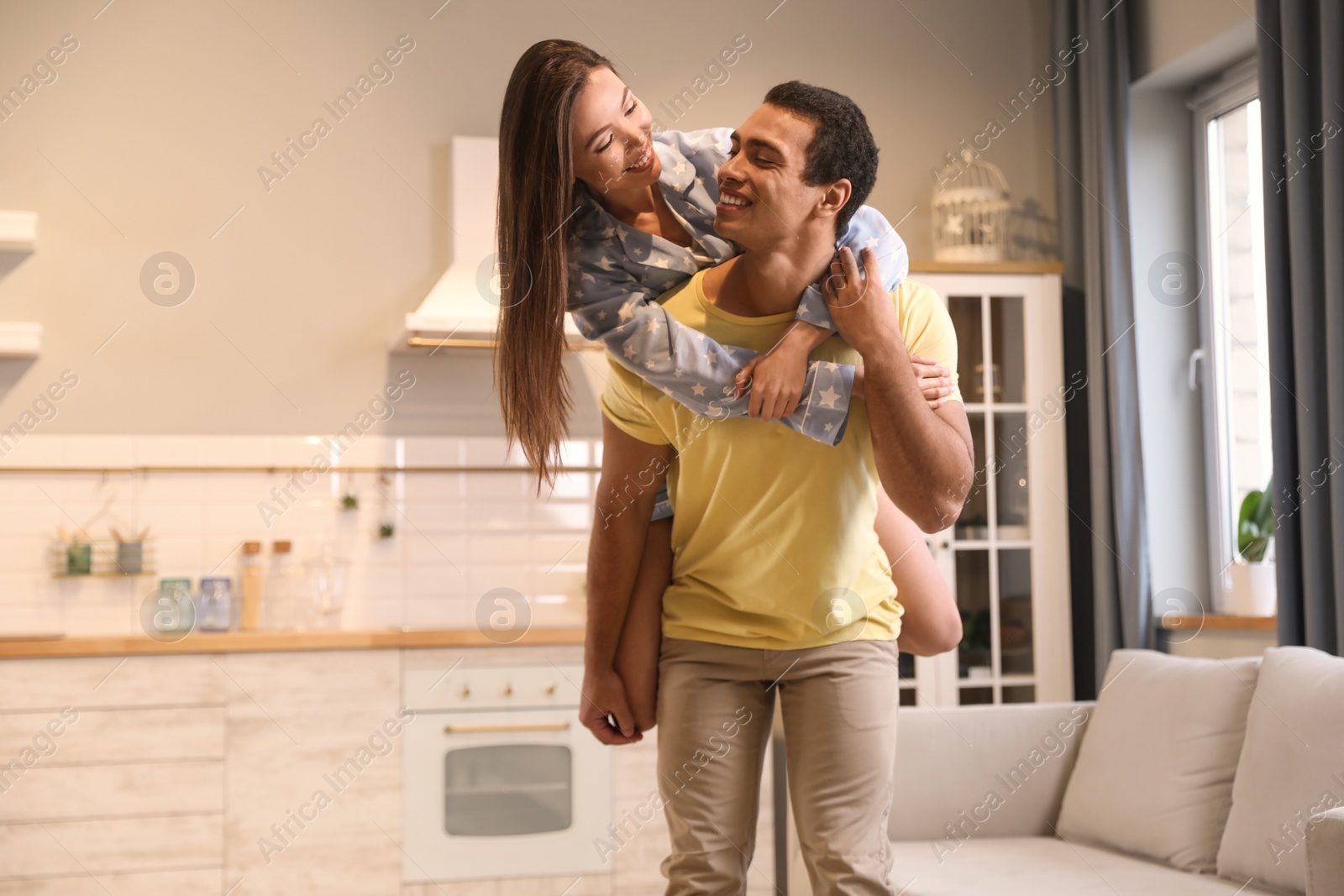 Photo of Lovely young interracial couple having fun at home