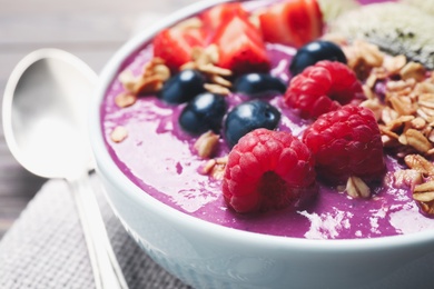 Photo of Delicious acai smoothie with raspberries and oatmeal in bowl, closeup