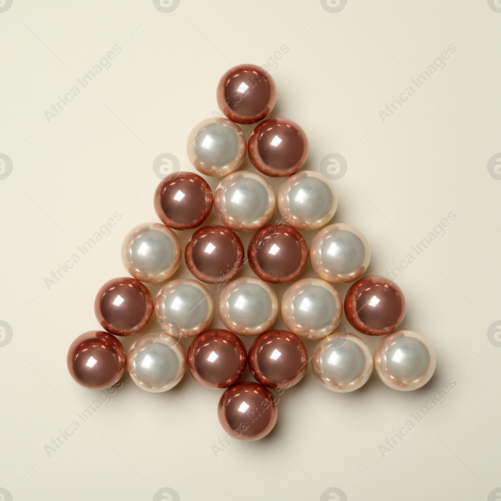 Photo of Christmas tree made of decorations on beige background, top view. Space for text