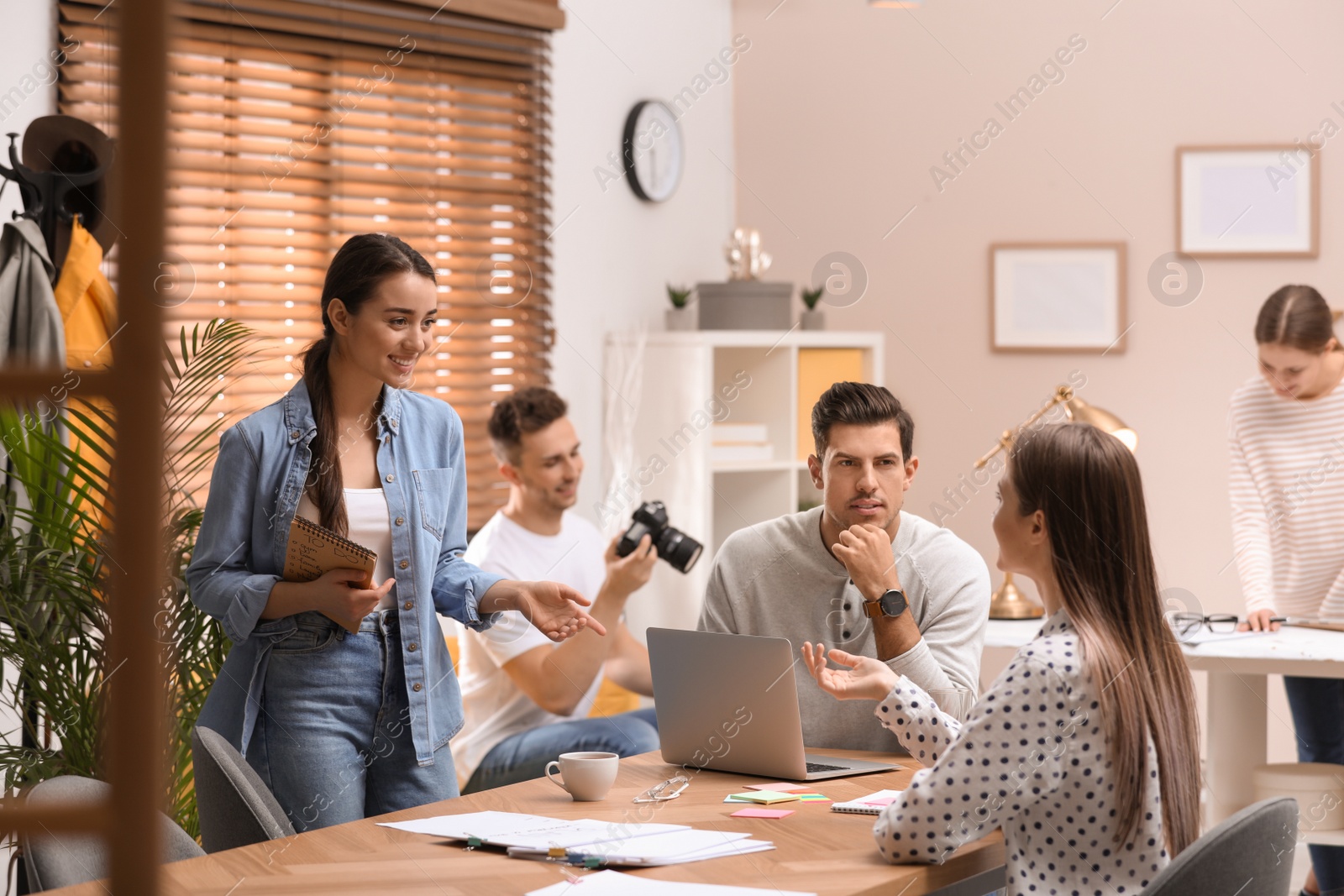 Photo of Team of professional journalists working in office