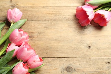 Photo of Happy Mother's Day. Beautiful pink tulips on wooden table, flat lay. Space for text