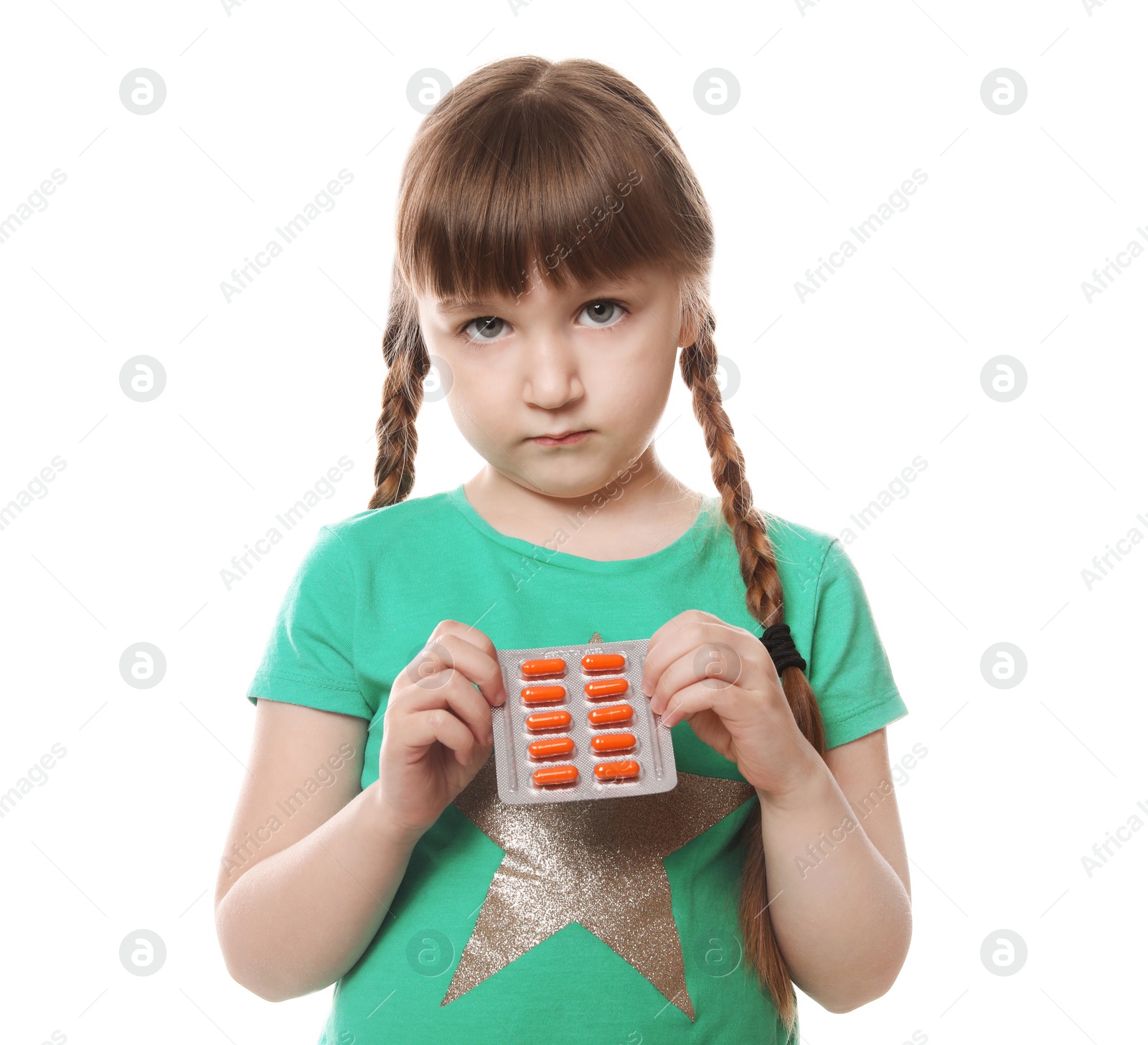 Photo of Little child with pills on white background. Danger of medicament intoxication