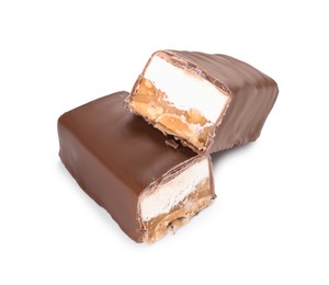 Photo of Pieces of tasty chocolate bars with nougat and nuts on white background