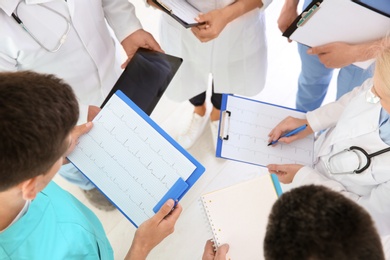 Photo of Group of doctors attending meeting in clinic. Cardiology conference