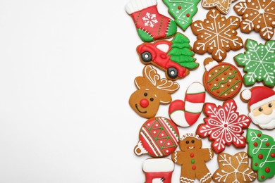 Different tasty Christmas cookies on white background, flat lay. Space for text