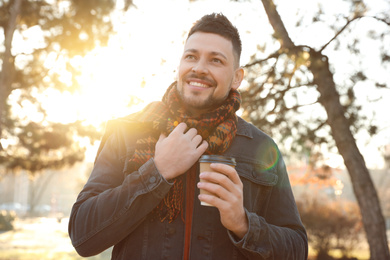 Man with cup of coffee in morning outdoors