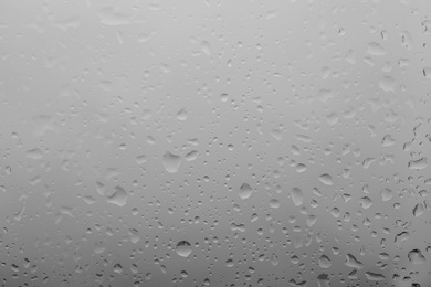 Water drops on light background, closeup view