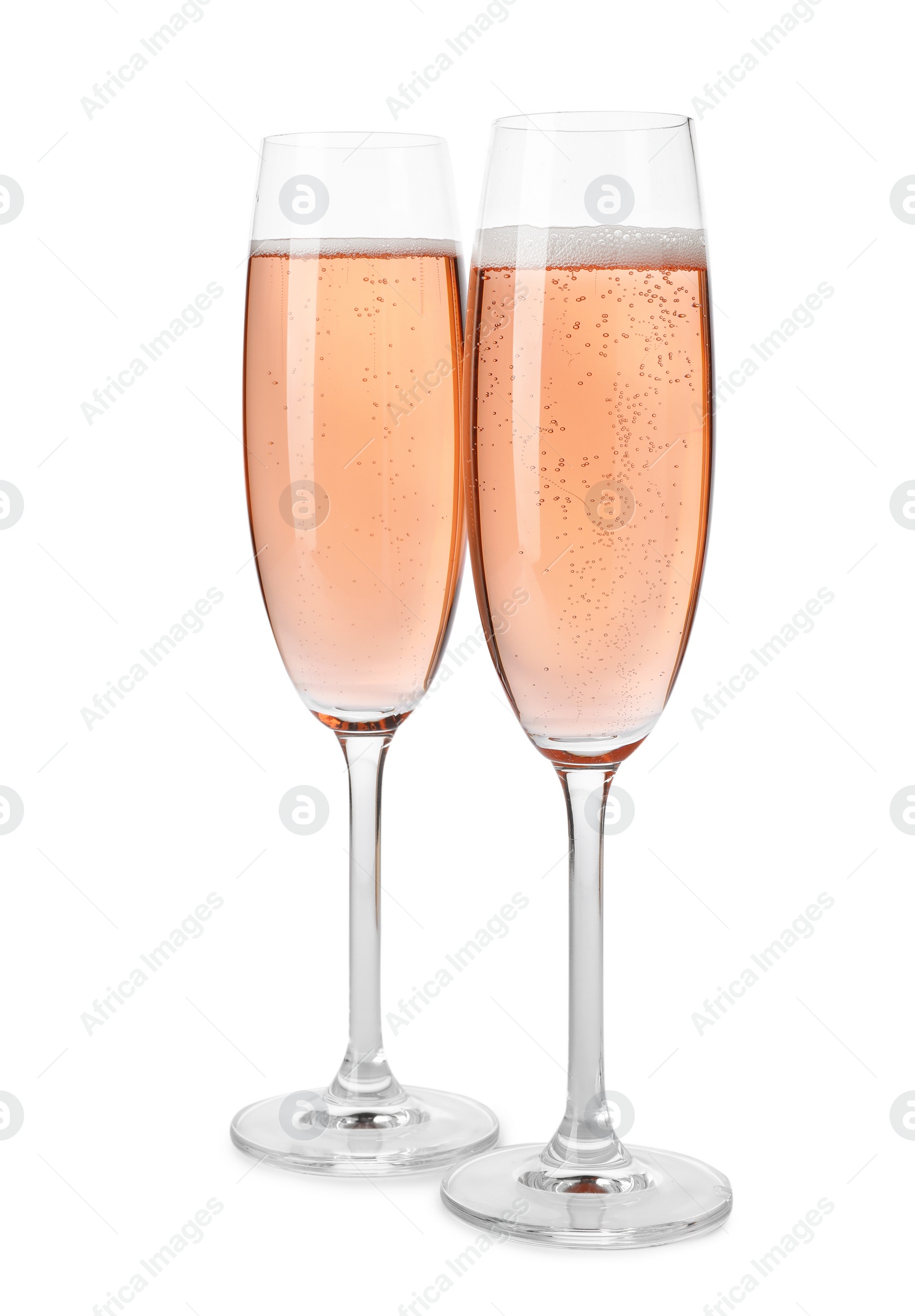 Photo of Glasses of rose champagne isolated on white