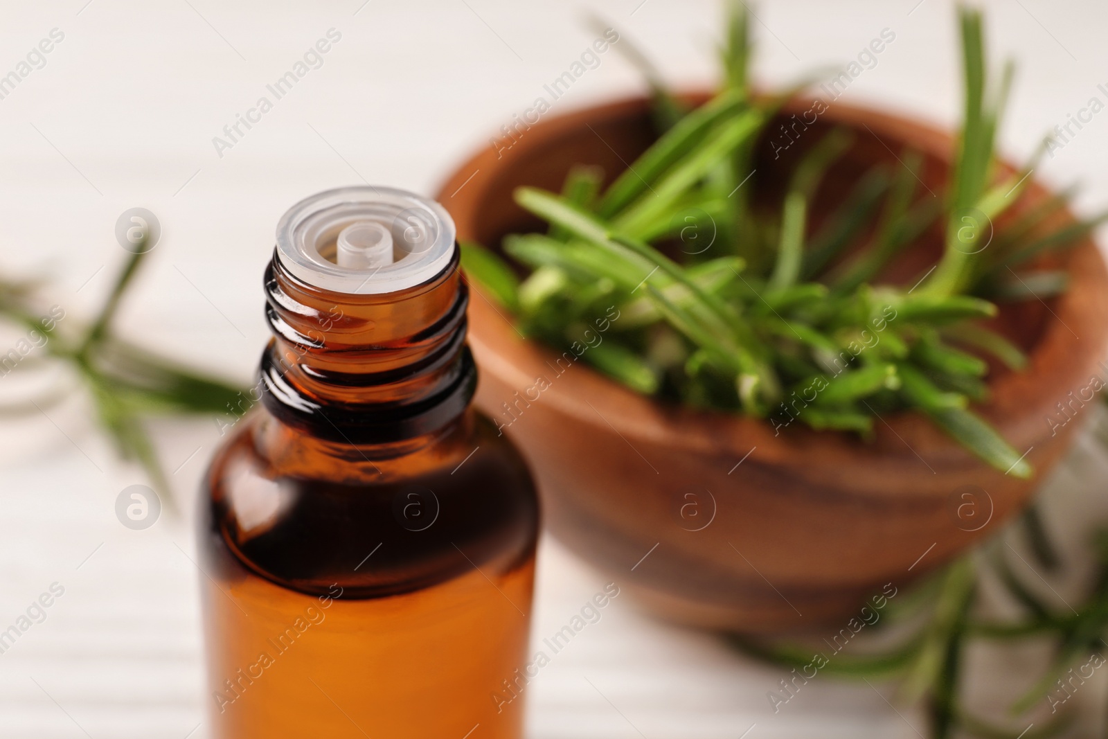 Photo of Bottle with essential oil against blurred background, closeup. Space for text