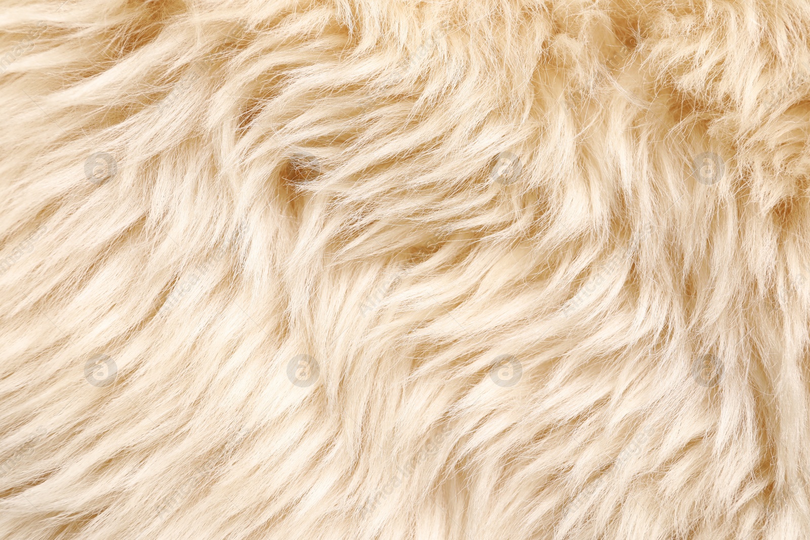 Photo of Texture of beige faux fur as background, top view