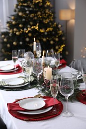 Christmas table setting with festive decor and dishware indoors