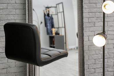 Photo of Comfortable chair near mirror in makeup room